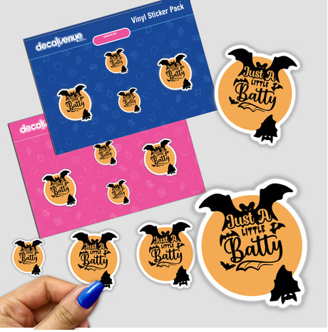 Sticker with Halloween Saying featuring black bats, held in a hand, close-up view.