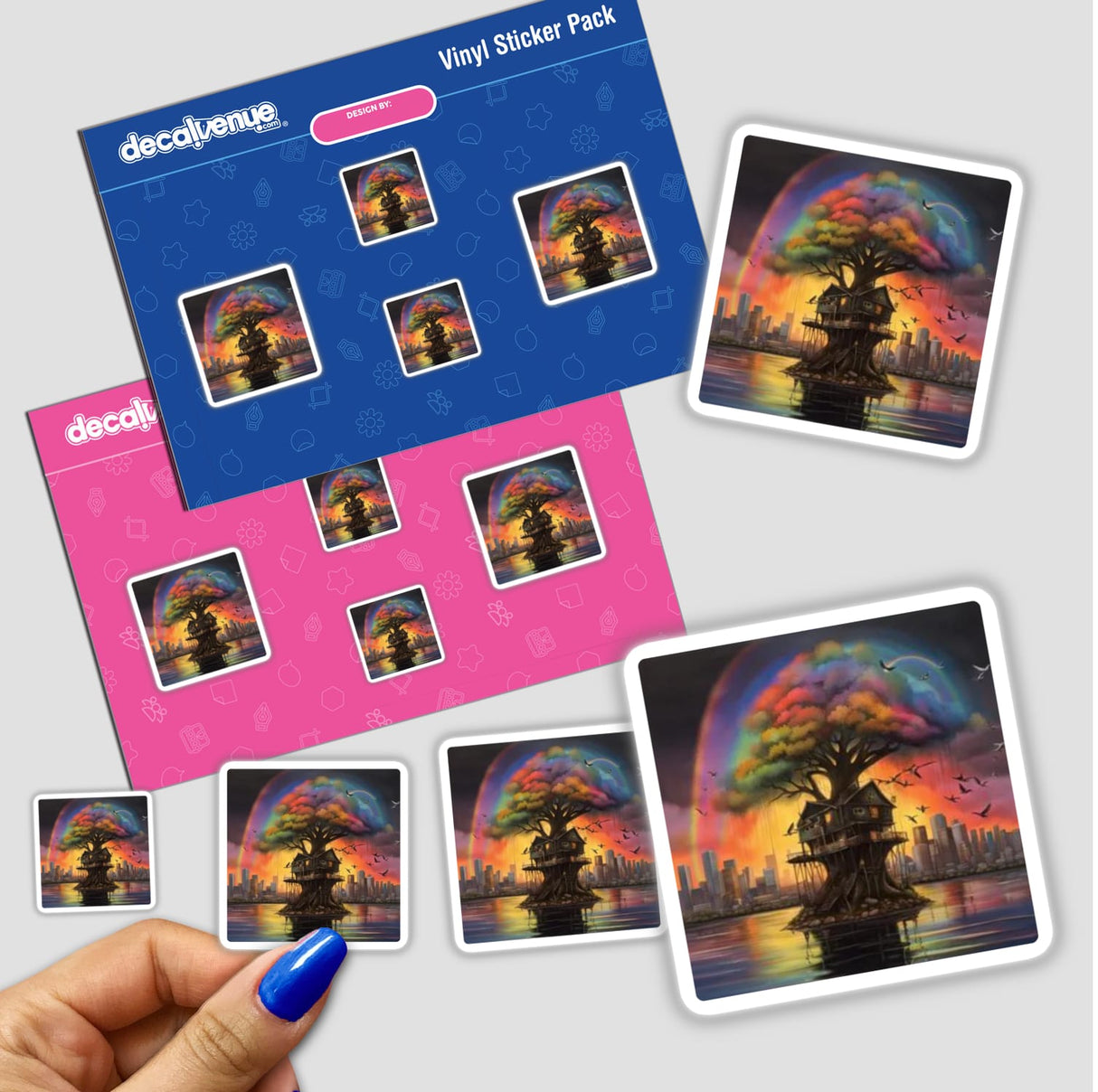 Fantasy Treehouse Collection Rainbow Life: A hand holds a sticker pack featuring vibrant treehouse scenes with rainbows and cityscapes, highlighting the unique style of Decal Venue's stickers and digital art.