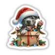 Santa Pitbull Dog in a Christmas Box III: A pitbull wearing a Santa hat sits in a box adorned with Christmas lights, available as unique stickers or digital artwork from Decal Venue.