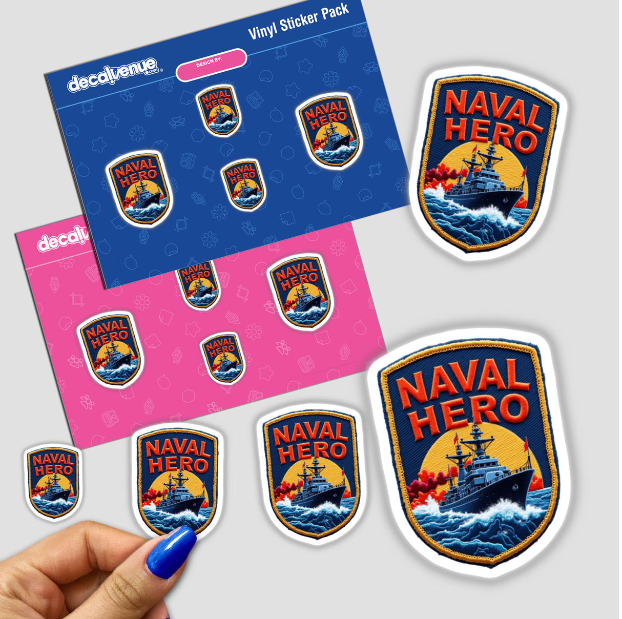 Hand holding 0004 - NAVAL HERO sticker featuring a ship. Variety of similar stickers and patches displayed around, highlighting unique naval-themed designs.