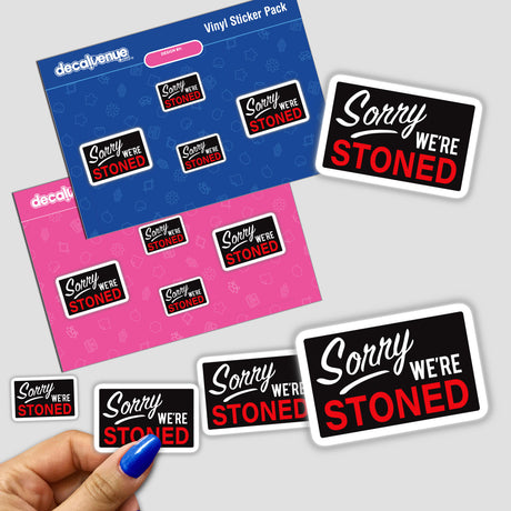 Hand holding the Sorry We're Stoned sticker pack, showcasing a collection of uniquely designed decals available as vinyl stickers or digital artwork.