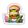 Cartoon frog holding a burger and a pink drink, titled Froggie Burger Delight, available as stickers or digital artwork.