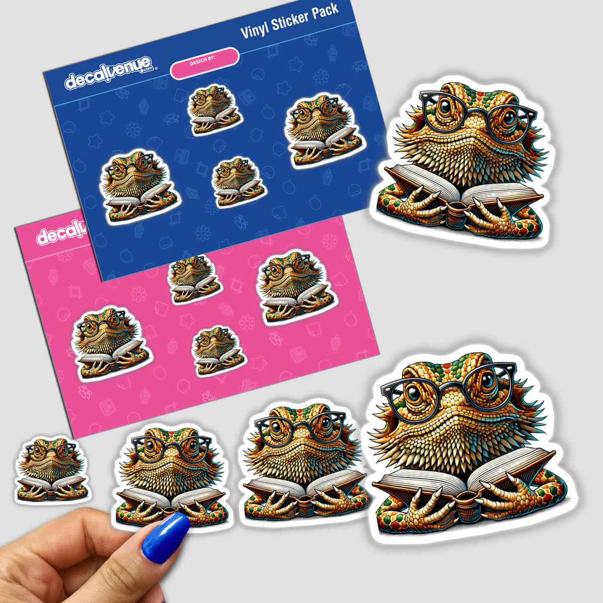 Bearded Dragon With Reading Glasses Open Book stickers, featuring a lizard wearing glasses while reading. A close-up showcases a hand holding the sticker pack, ideal for unique vinyl collections.