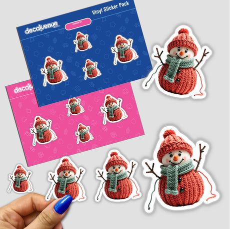 Knitted Yarn Snowman sticker pack held in a hand, featuring cartoon snowmen with scarves and hats. Part of Decal Venue's unique collection of stickers and digital art.