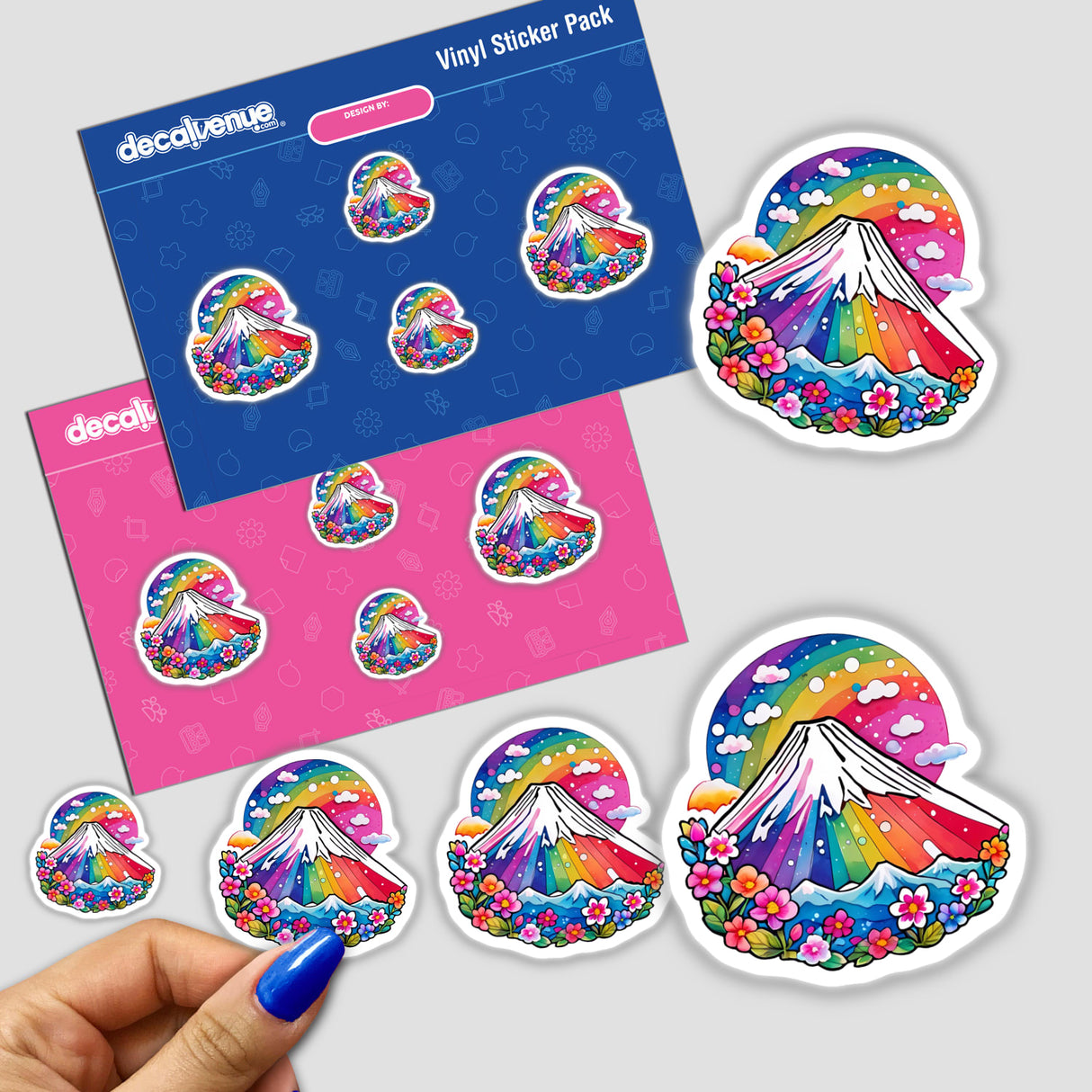 Sticker pack featuring Rainbow Mt. Fuji Japan design with mountains, flowers, and clouds; close-up of a hand applying a sticker, available as physical stickers or digital artwork.