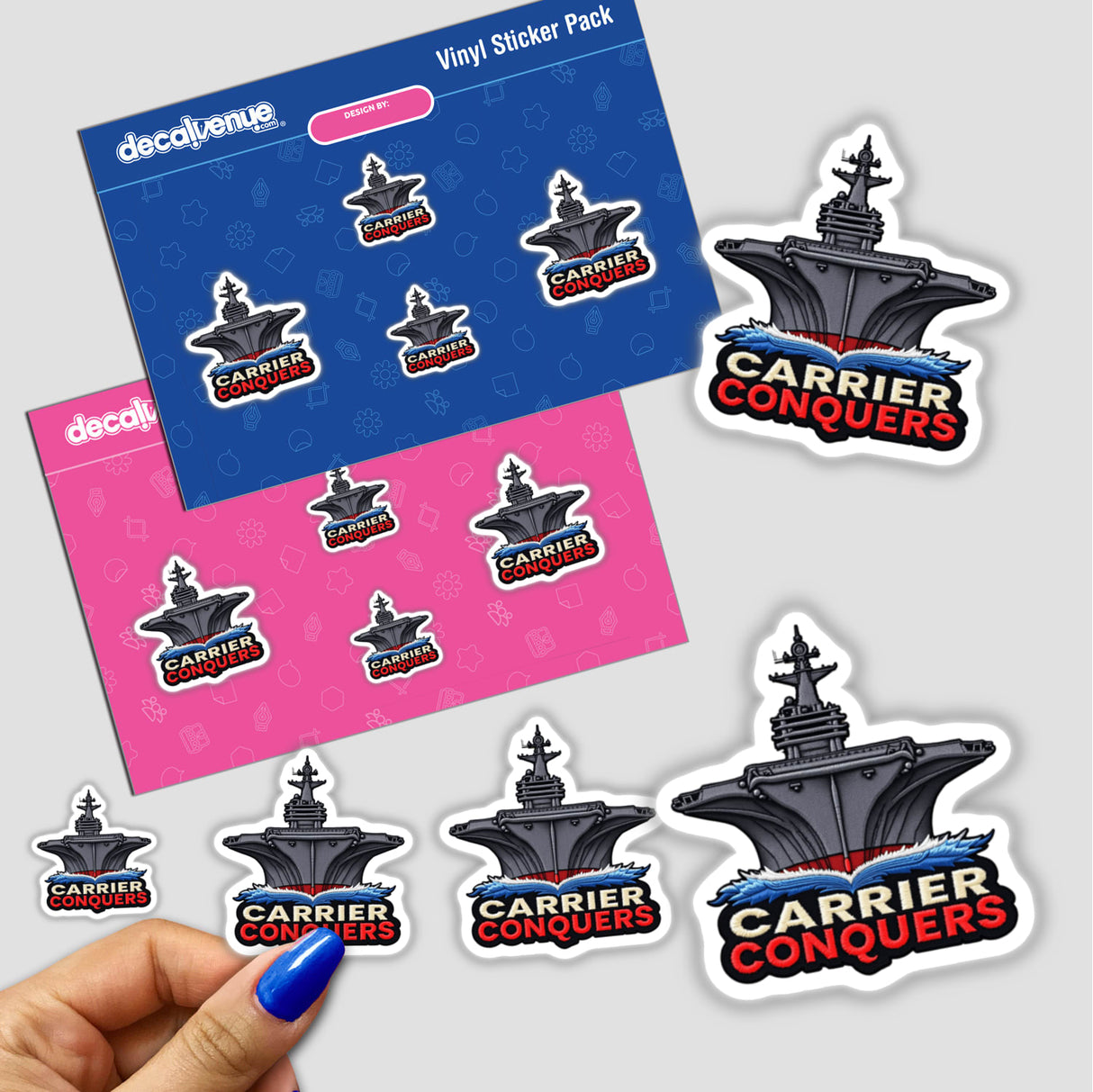 Stickers featuring the '0006 - CARRIER CONQUERS' design, showcasing a ship graphic. A hand with blue nail polish is seen applying one of the stickers.