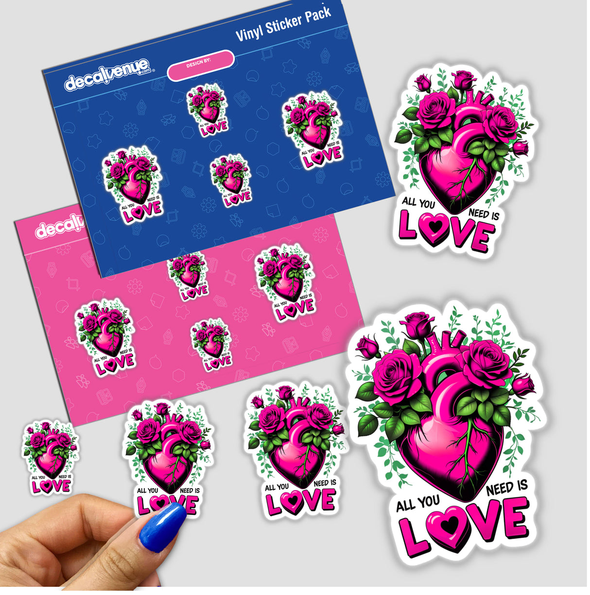 Hand holding a pack of All You Need Is Love stickers featuring hearts and floral designs, showcasing unique vinyl sticker offerings from Decal Venue.