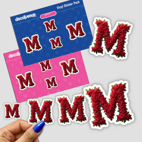 Hand holding Elegant Floral Letter M Clipart sticker, showing intricate rose design, available as downloadable artwork with commercial rights.