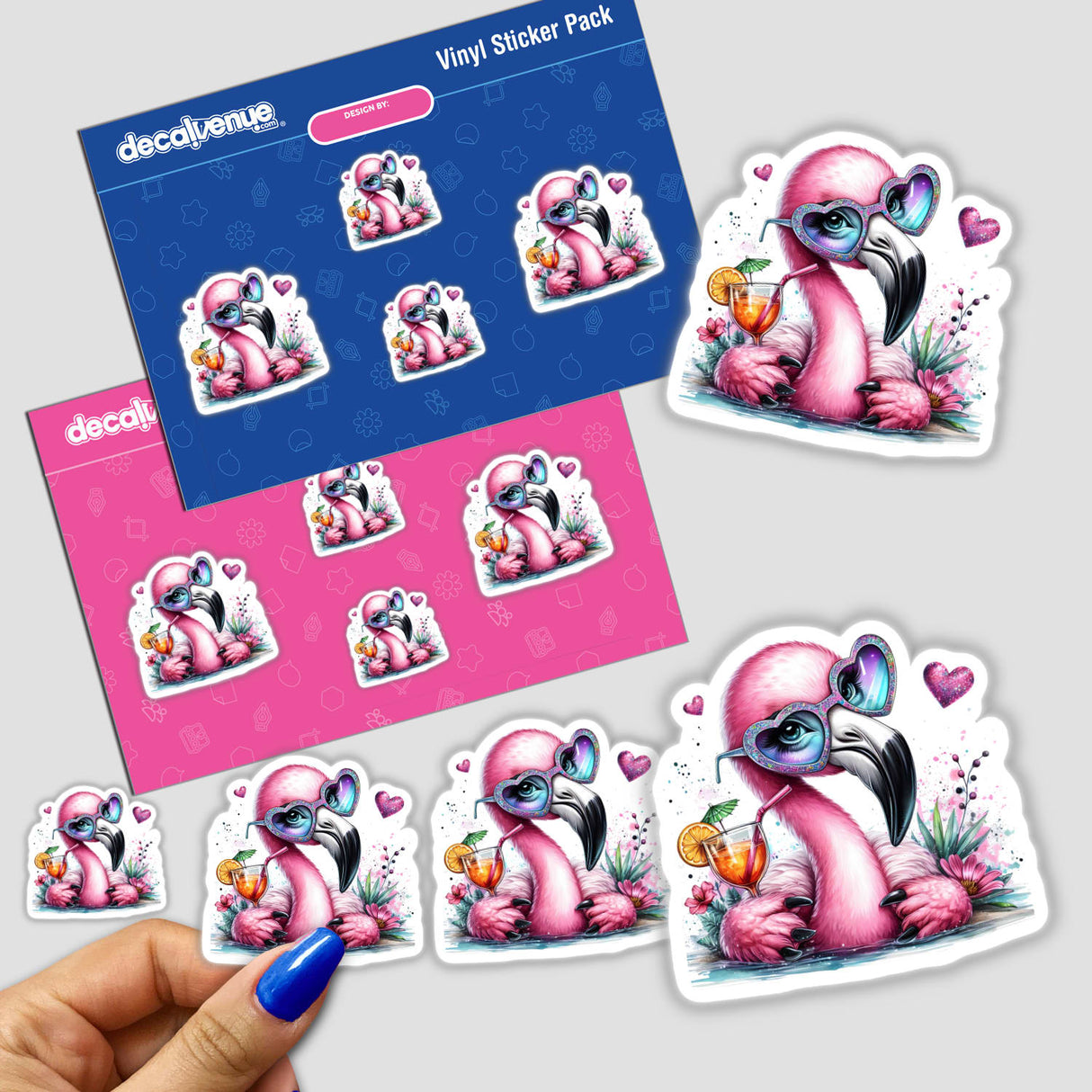 Adorable pink flamingo digital artwork stickers with tropical drink and floral accents, displayed on a blue and pink vinyl sticker pack from Decal Venue.