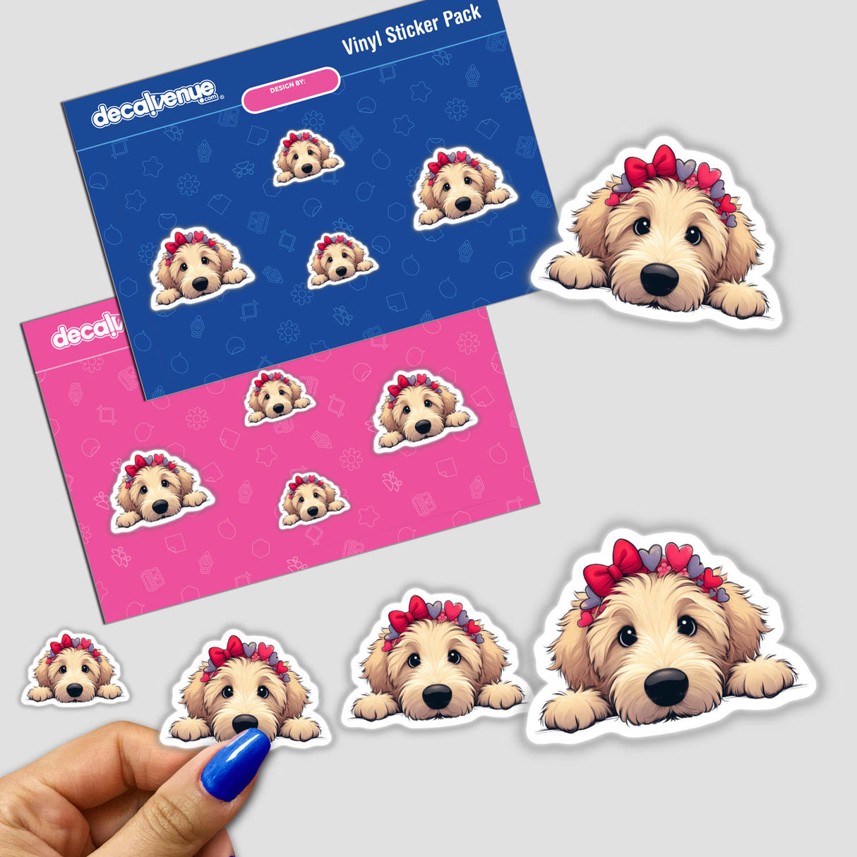 Peeking Goldendoodle w Heart Headband sticker, featuring a cartoon dog with a heart-themed headband, held by a hand. Available as stickers or digital artwork from Decal Venue.