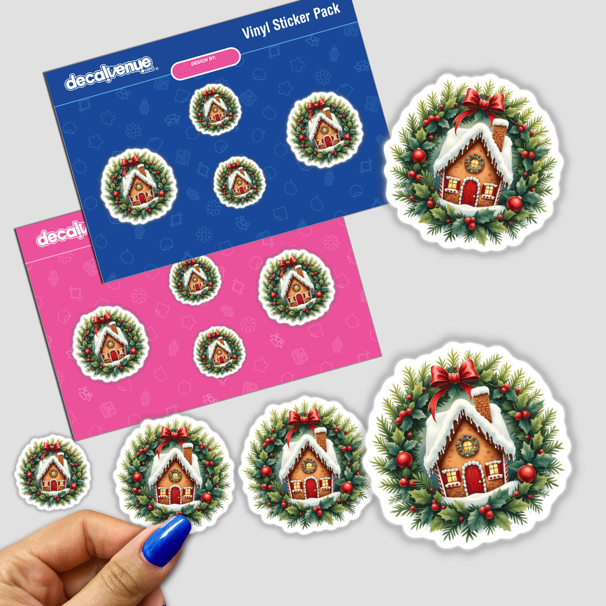 Gingerbread House in a Christmas Wreath sticker pack, featuring intricate designs of houses nestled in wreaths, held by a hand. Available as stickers or digital artwork from Decal Venue.