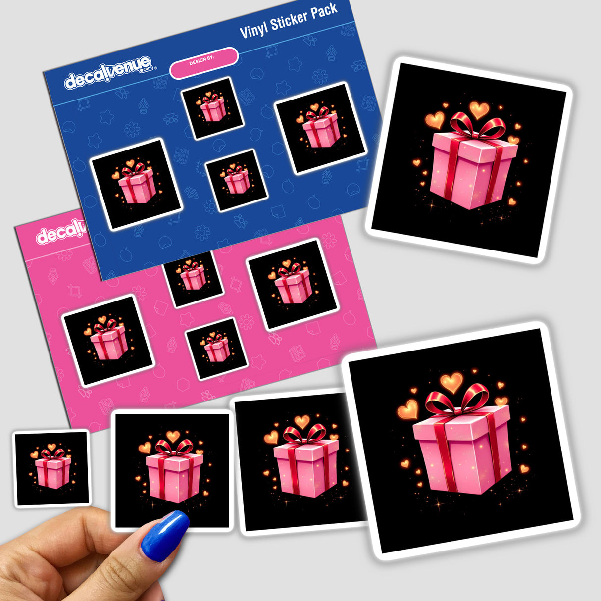 Sticker pack titled Pink Gift Box with Red Ribbon and Gold Hearts, featuring a hand holding vibrant stickers, ideal for creative projects. Available as stickers or digital artwork from Decal Venue.