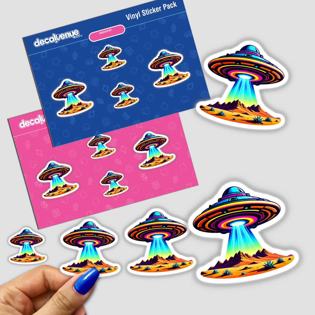 Sticker titled A UFO Flying Over The Desert, featuring a colorful cartoon UFO with a rainbow beam, available as a sticker or digital artwork from Decal Venue.