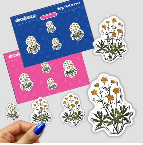 American Wild Flowers stickers featuring various floral designs, including yellow flowers, displayed on a surface. A hand with blue nail polish holds one, showcasing the intricate details of each sticker.