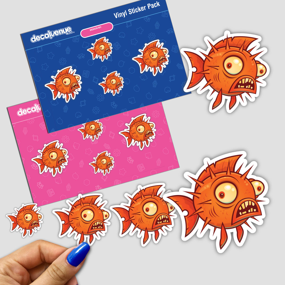 Pufferfish sticker pack featuring cartoon orange fish with open mouths and sharp teeth, held in hand, showcasing unique and playful designs from Decal Venue.