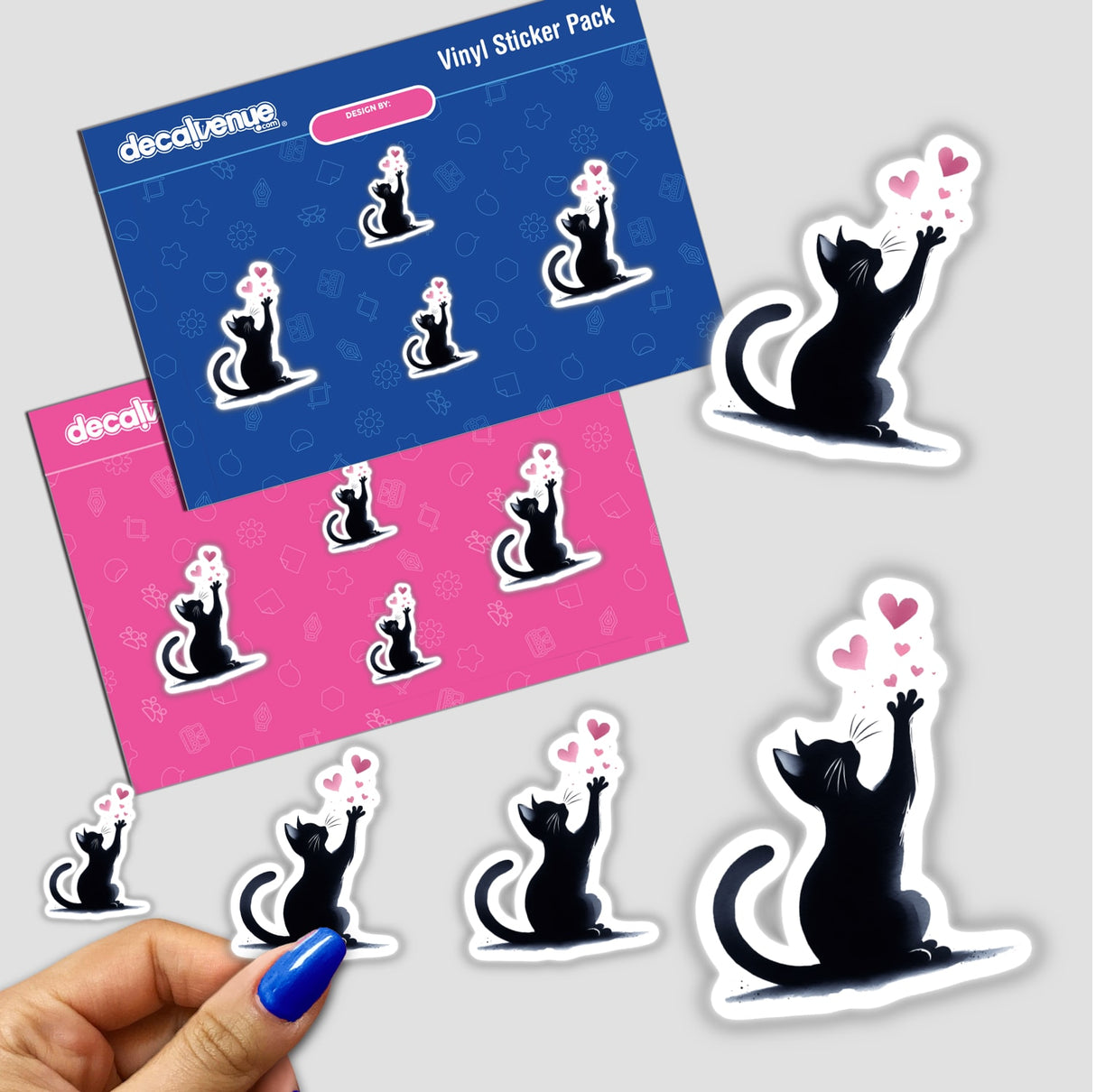 Colorful vinyl stickers featuring a playful black cat design reaching for pink hearts. The stickers are part of a product pack sold by Decal Venue, an online store specializing in unique digital artworks and stickers.