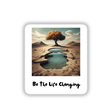 Be the Life Changing Motivation Quotes sticker featuring a tree with orange leaves and a pond, symbolizing growth and inspiration amidst a serene desert landscape.