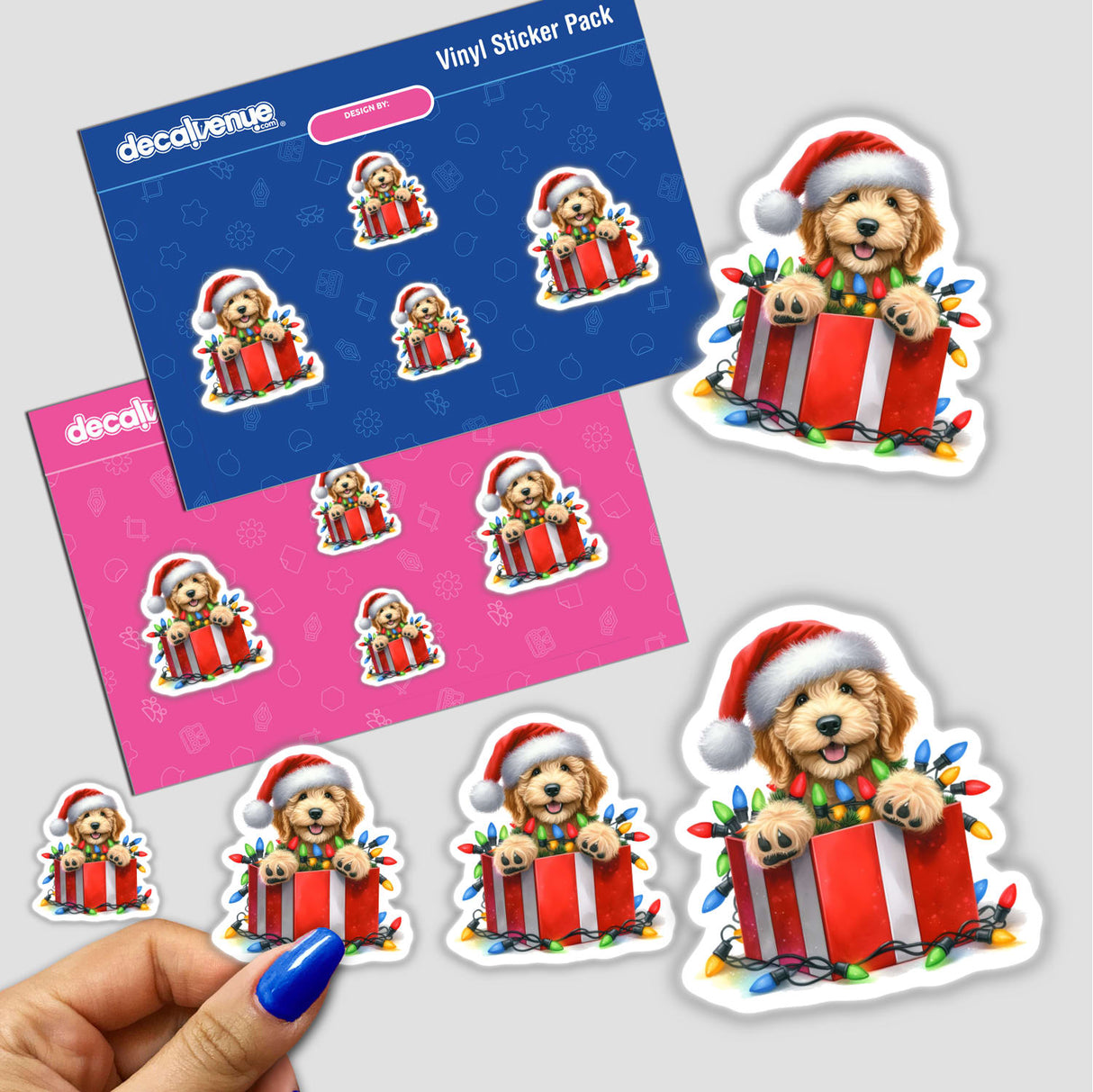 Christmas Lights Santa Golden Doodle Dog in Gift Box II sticker depicts a cartoon dog in a gift box adorned with festive lights and a Santa hat, available as stickers or digital artwork.