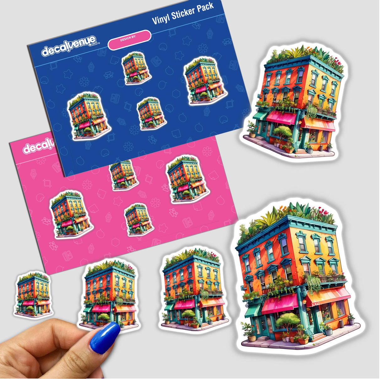 Hand holding a sticker pack titled Vibrant NYC Building Full of Plants, featuring colorful buildings adorned with greenery. Available as stickers or digital artwork from Decal Venue.