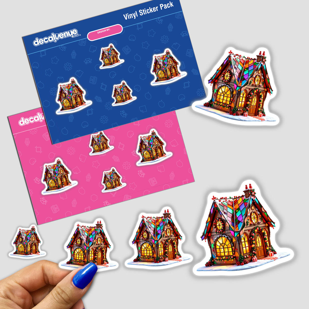 Gingerbread House Stained Glass Art stickers feature colorful, illuminated house designs, with a hand showcasing the intricate details. Available as unique stickers or digital artwork from Decal Venue.