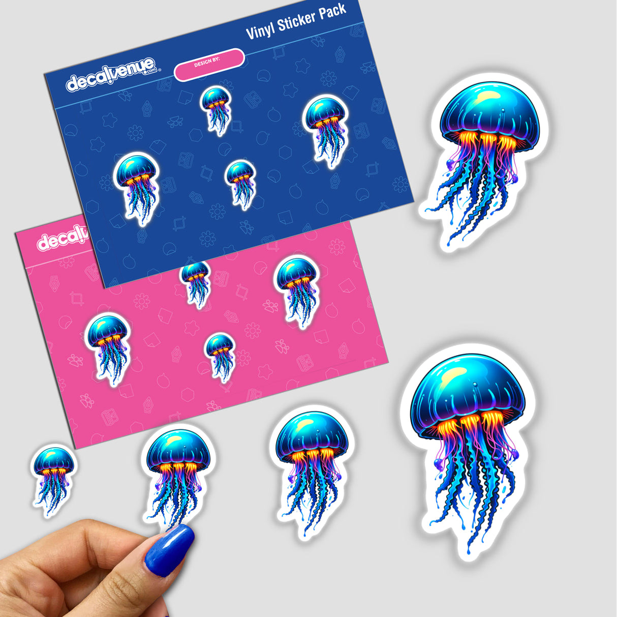 Blue Jellyfish stickers featuring vibrant designs are shown, including a blue jellyfish with orange tentacles. A hand with blue nail polish gently holds one, highlighting the product's intricate details.