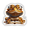 Bearded Dragon With Reading Glasses Open Book: A cartoon illustration depicting a bearded dragon wearing glasses, immersed in a book, available as unique stickers or digital artwork.