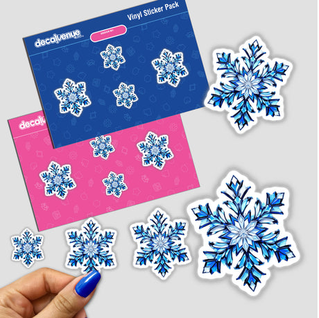 Hand displaying the 'Snowflake Stained Glass Style' sticker pack, showcasing intricate snowflake designs available as stickers or digital artwork from Decal Venue.