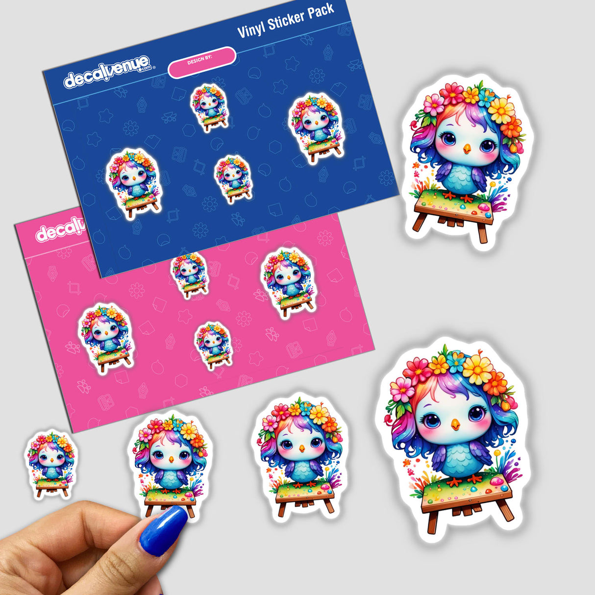 Hand holding a sticker pack featuring cute bird cartoon characters with flowers in their hair, available as stickers or digital artwork from Decal Venue.