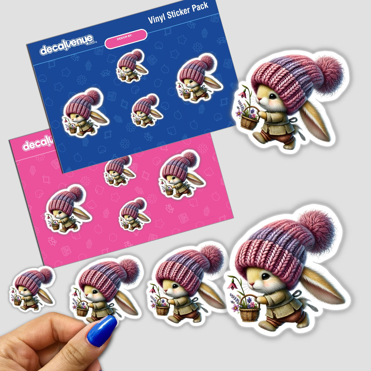 Colorful digital artwork stickers of a whimsical bunny gnome character in a knit hat, carrying a tiny basket. The image showcases a set of these stickers against a patterned background.