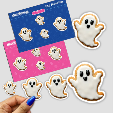 Hand holding a sticker pack featuring ghost-shaped cookies with white icing and black eyes, available as stickers or digital artwork.