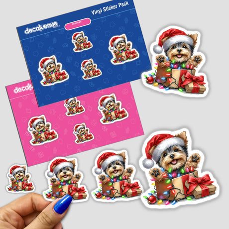 Sticker featuring a cartoon Yorkie in a Santa hat, sitting in a gift box adorned with Christmas lights, titled Christmas Lights Santa Yorkie in Gift Box IV. Available as stickers or digital artwork.