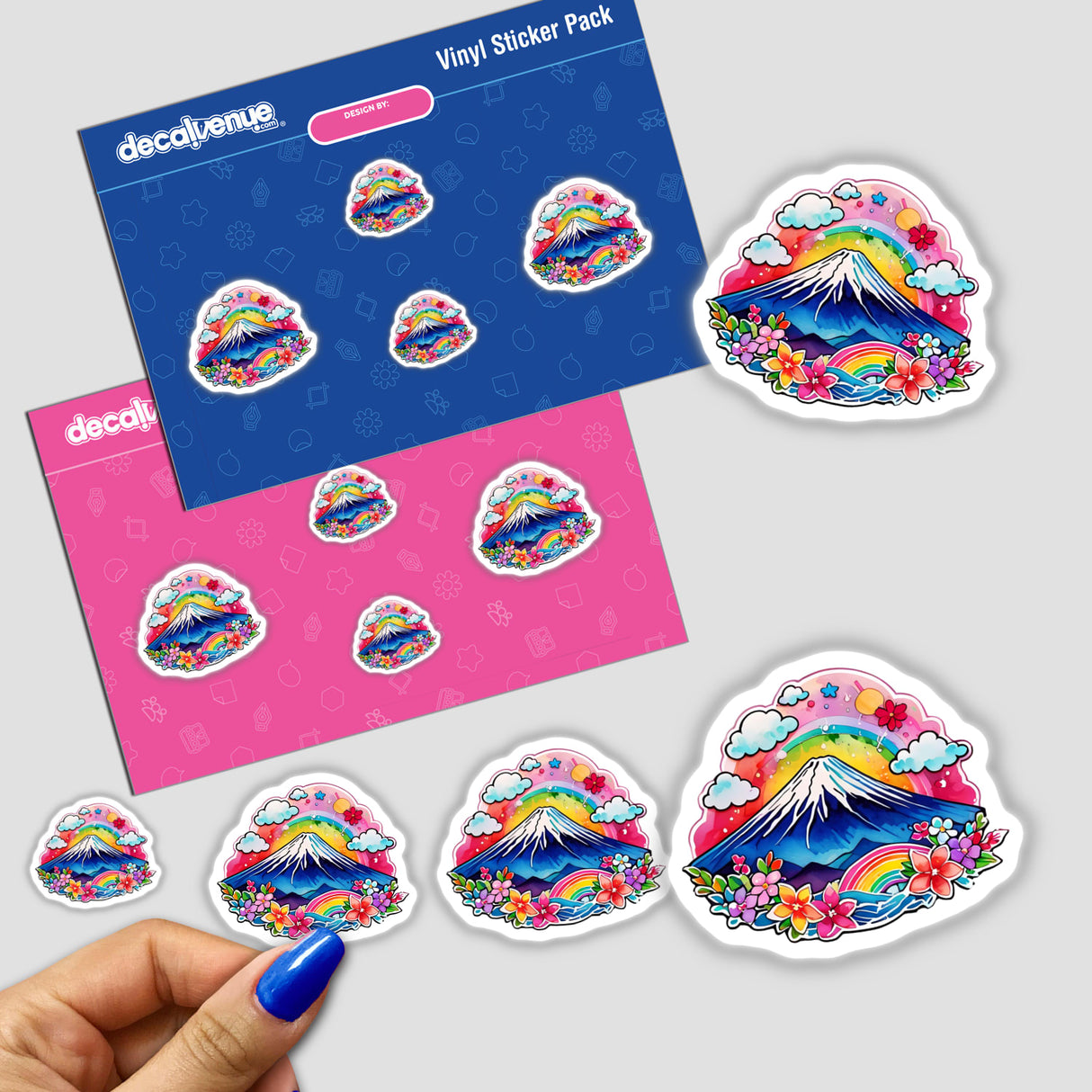 Sticker pack featuring colorful designs of Rainbow Mt. Fuji Japan, including mountains, flowers, and rainbows, with a close-up of a person's finger holding one of the stickers.