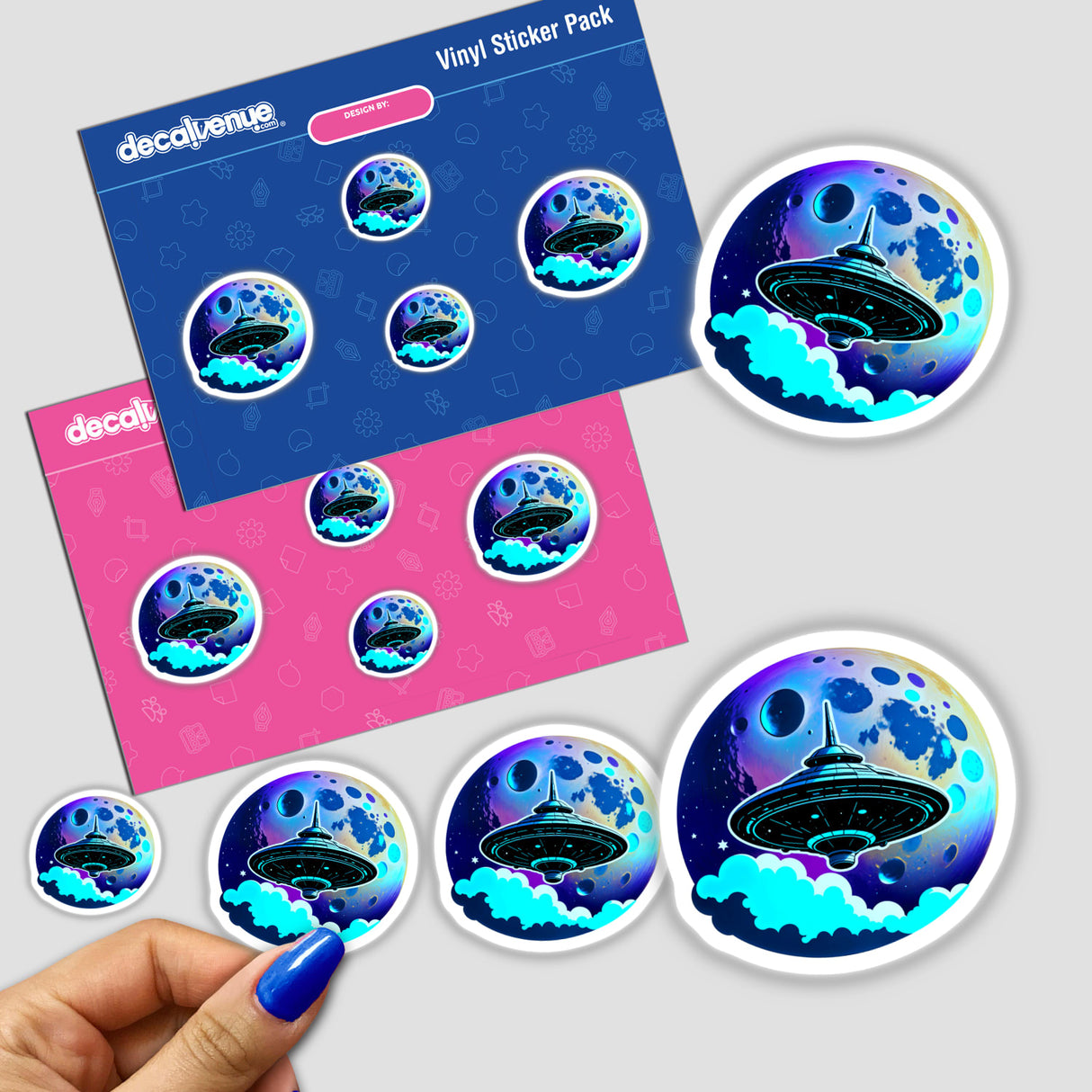 A hand holds a round sticker titled A UFO In Front Of A Moon, featuring a UFO against a sky backdrop. Available as unique stickers or digital artwork from Decal Venue.