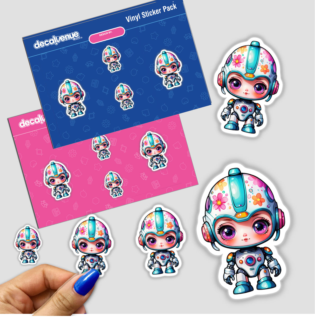 Kawaii Sci-Fi Robot Sticker featuring cartoon characters with helmets and vibrant eyes, displayed on a hand showcasing blue nail polish.