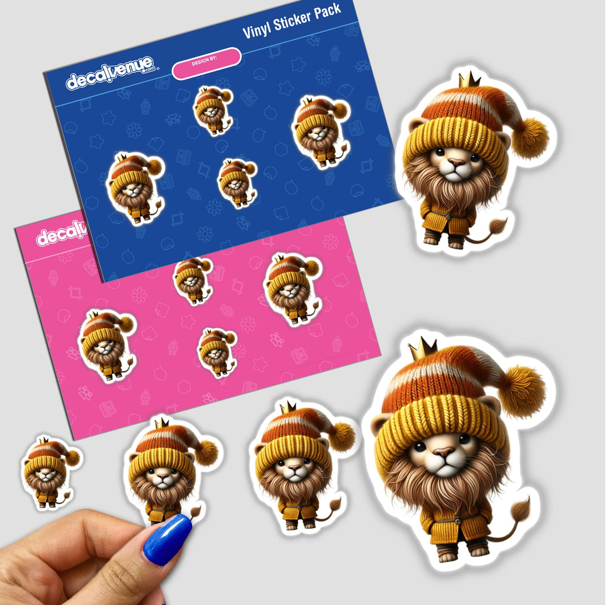 Cute digital stickers of a lion gnome wearing a tiny crown, surrounded by a pink and blue pattern background. The stickers feature the adorable lion gnome in various poses and expressions, showcasing its charming, hand-drawn design style. These stickers are available for purchase on the Decal Venue online store, which offers a variety of unique digital artwork and stickers created by talented designers.