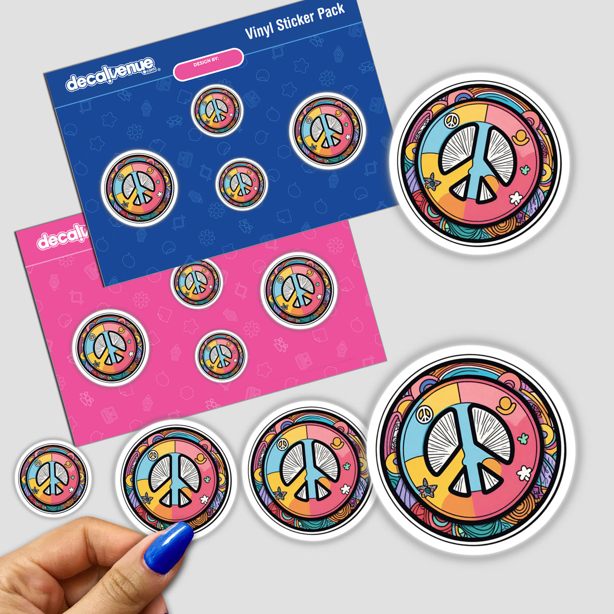 Colorful peace symbol stickers on a blue and pink background, featuring various sizes of the iconic peace sign design. The stickers appear to be part of a vinyl sticker pack from the Decal Venue store, showcasing the artistic and vibrant peace symbol motif.