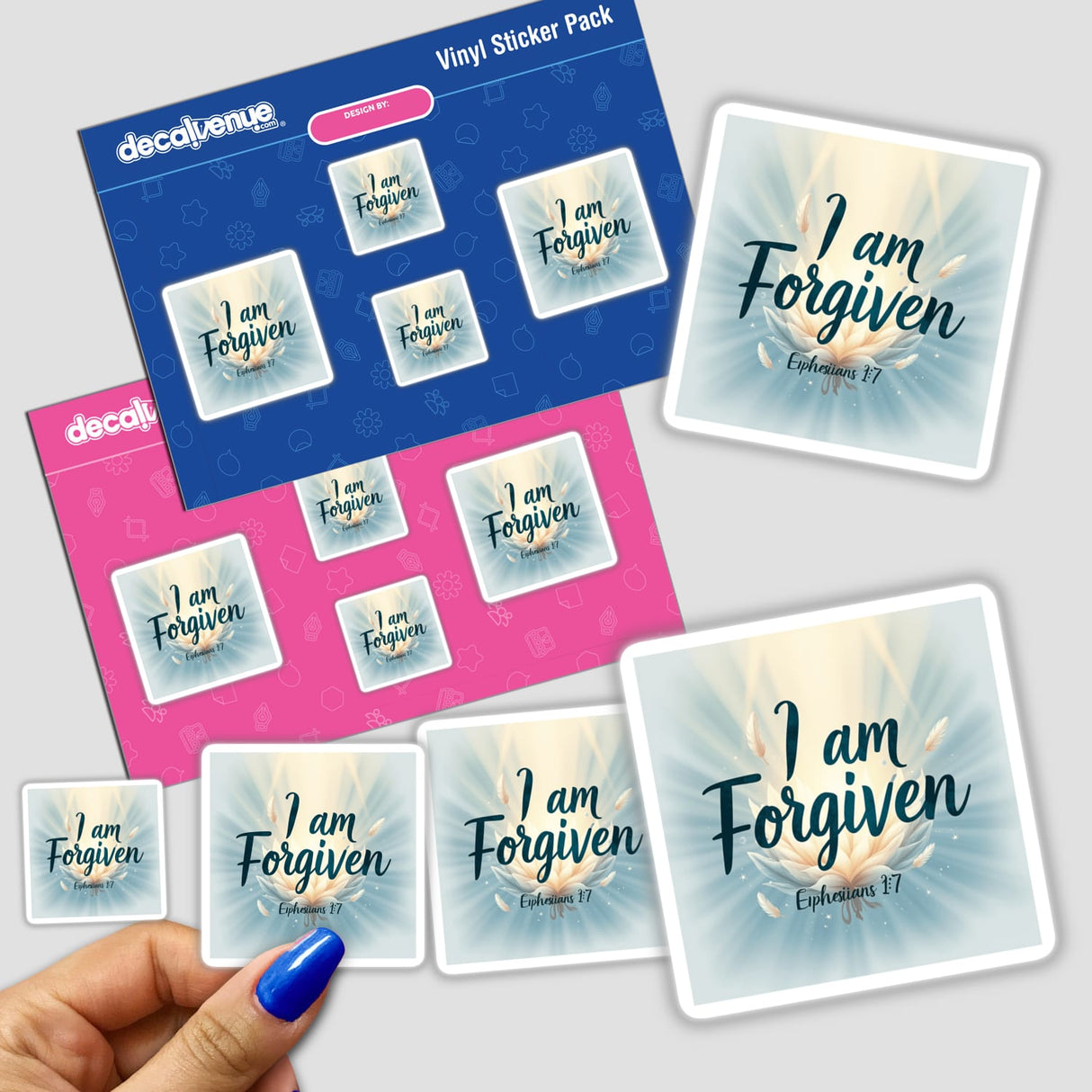 Hand holding 'I Am Forgiven - Ephesians 1:7' sticker pack, showcasing Christian faith-based designs available as stickers or digital clipart with commercial rights from Decal Venue.