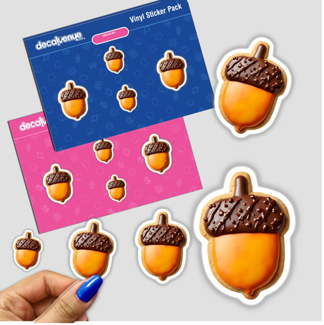 Acorn Shaped Cookie with Brown Cap and Golden Base surrounded by a sticker pack of acorns, highlighting Decal Venue's unique offerings.