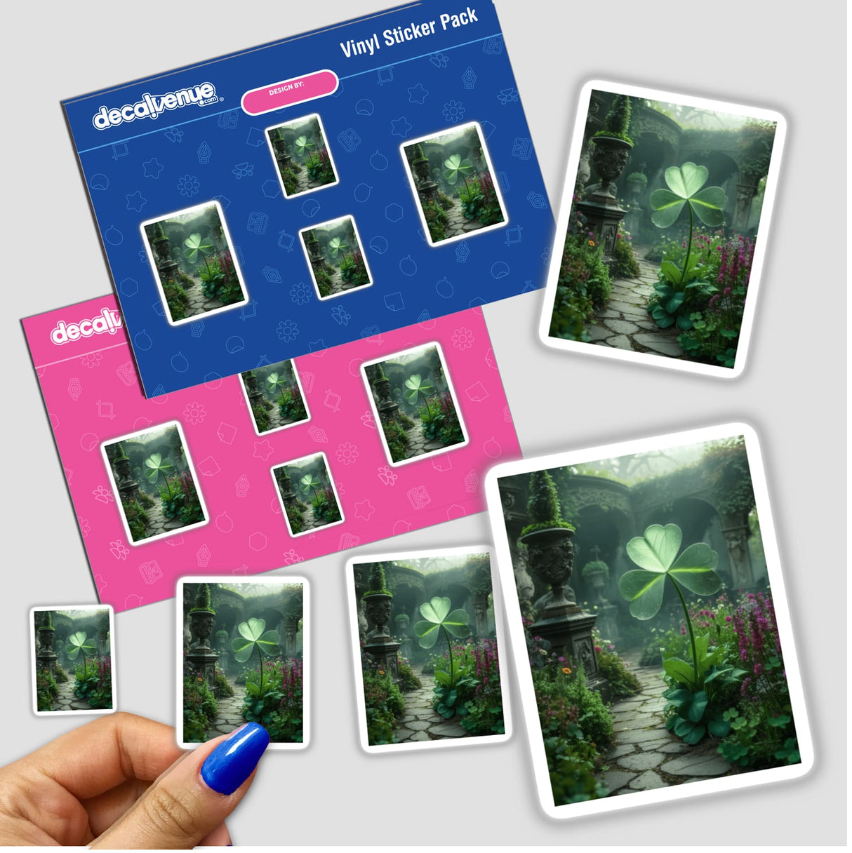 Mystical Shamrock – Dew-Kissed Clover in an Enchanted Garden sticker pack, featuring photos of clovers and garden scenes, held in a hand with blue nail polish.