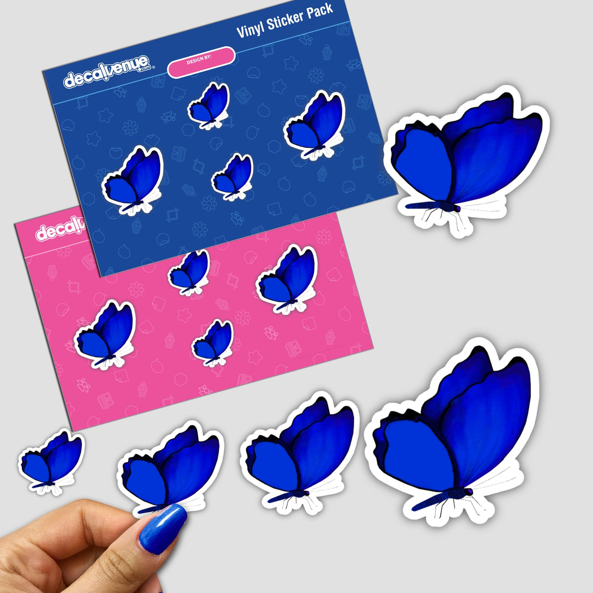 Hand holding a sticker pack with various blue and black butterfly designs.